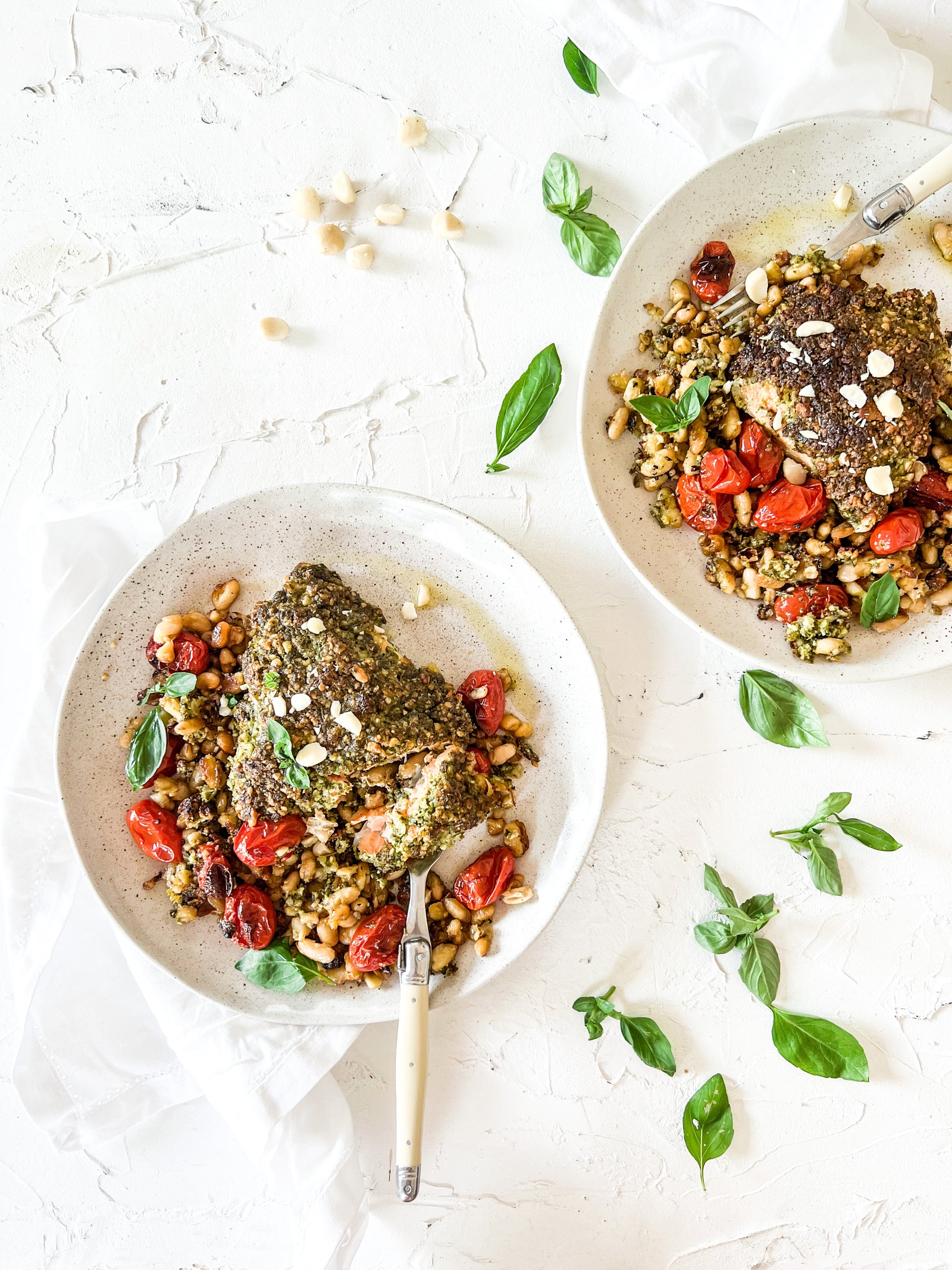 Basil macadamia pesto crusted salmon with roasted tomatoes and cannelloni beans
